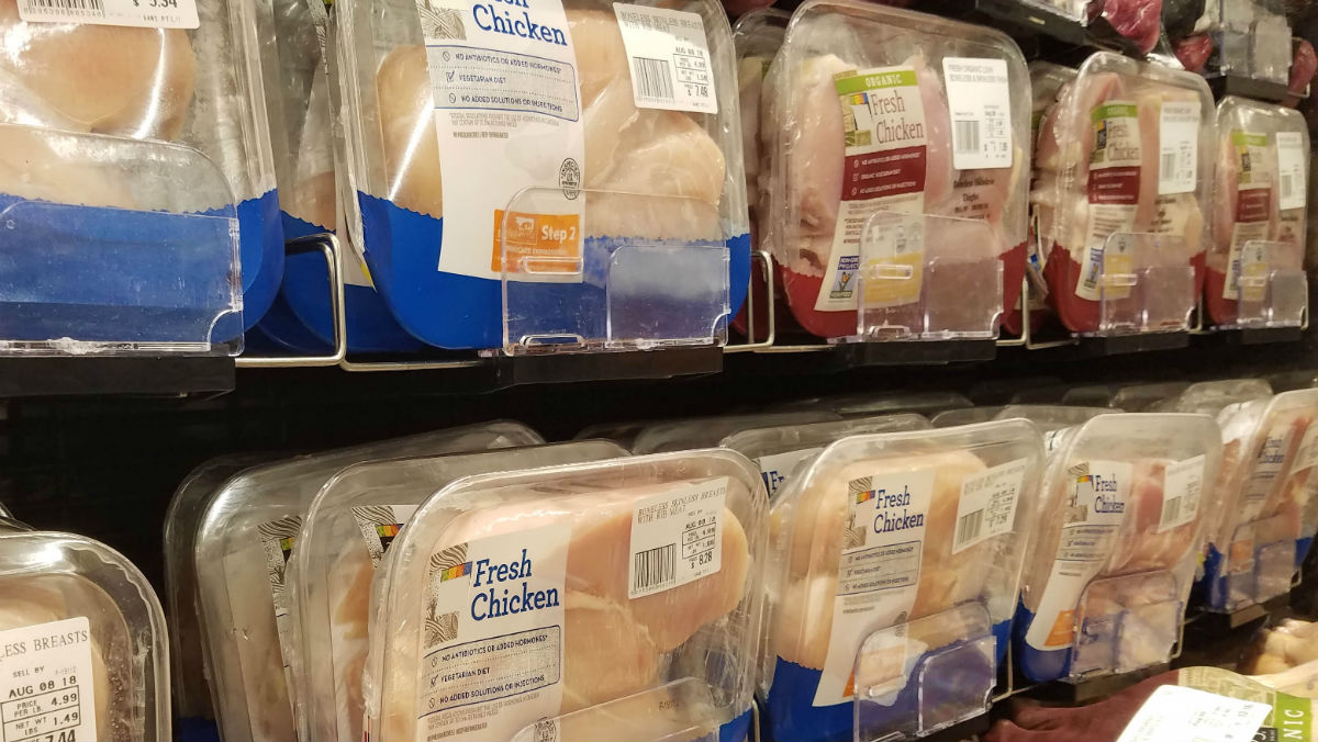 PET plastic food trays with poultry on the store shelf